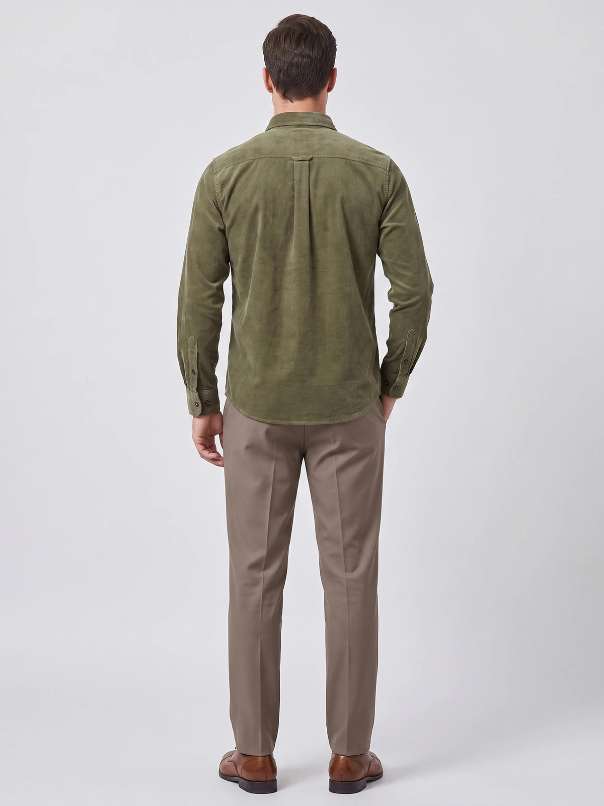 Rear studio view of a model wearing a Green Twill Tweed Shirt, showing the back yoke, center pleat, and button cuffs.
