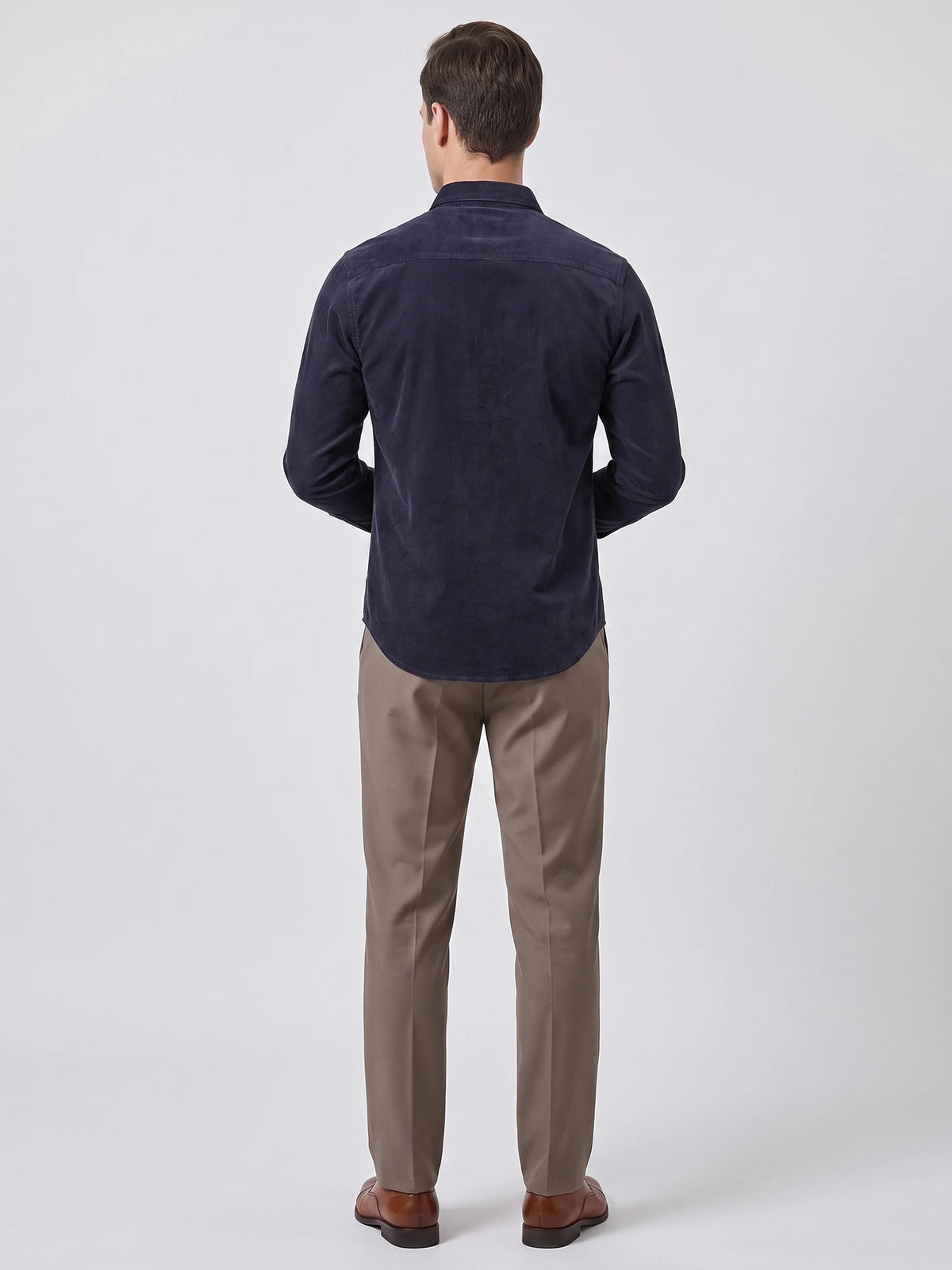 Rear studio view of a model wearing the Navy Twill Tweed Shirt, showing its back yoke and curved hem.