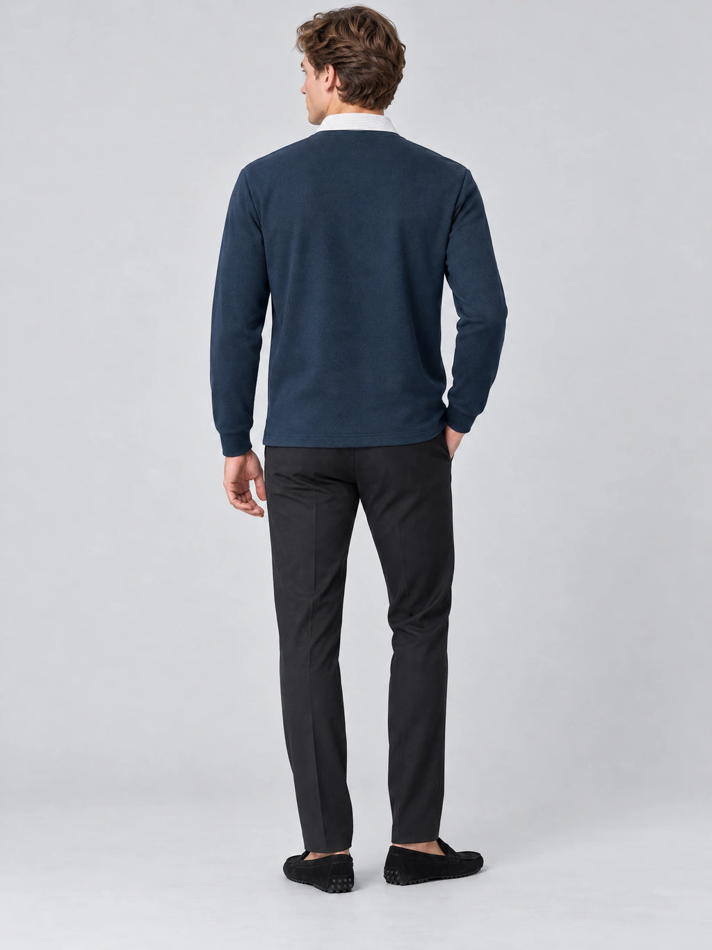 Rear studio view of a model wearing a Navy two-piece polo shirt with long sleeves and a contrasting collar.