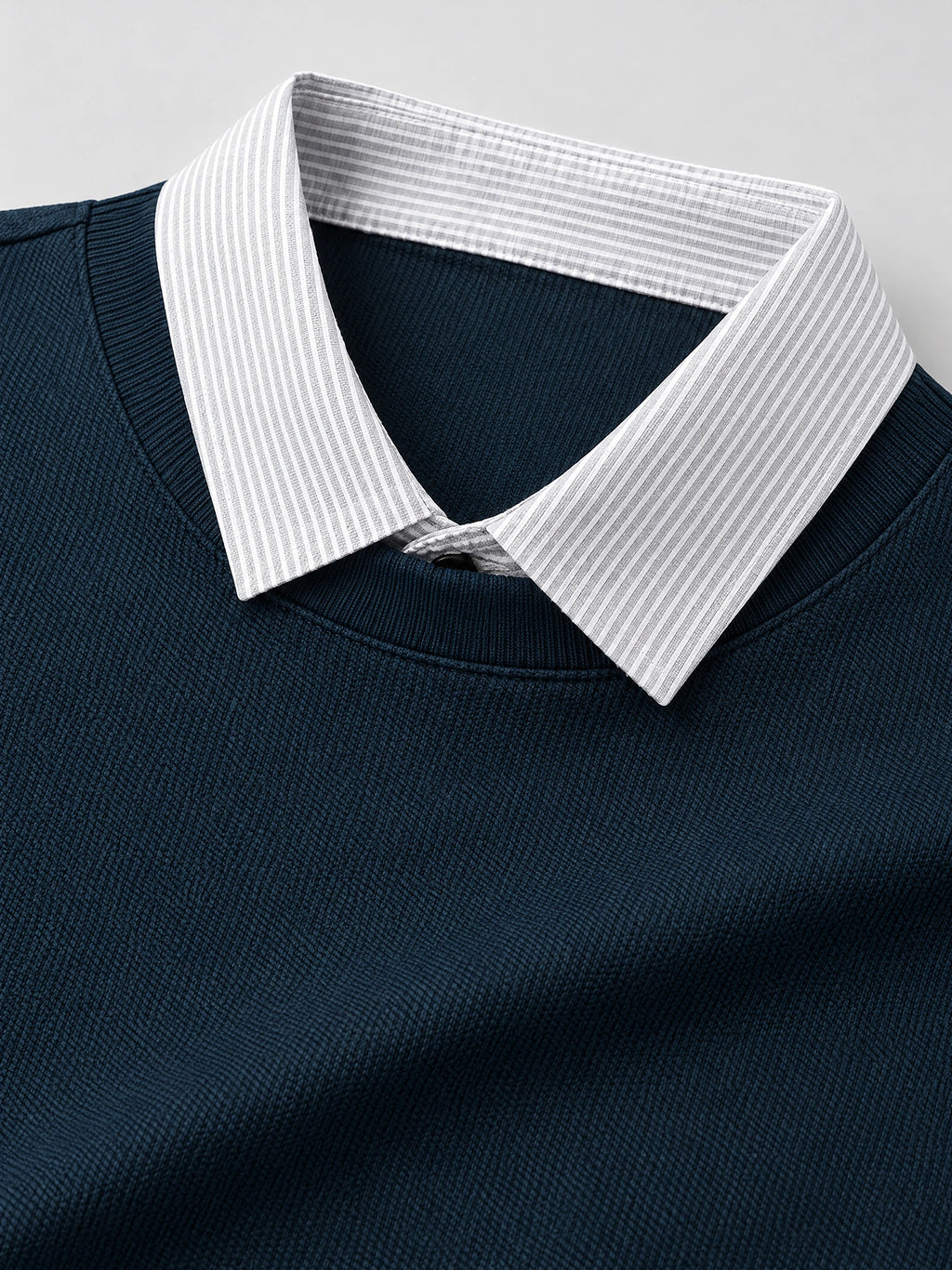Close-up of the Navy Two Piece Polo Shirt with a striped layered collar and textured knit fabric.