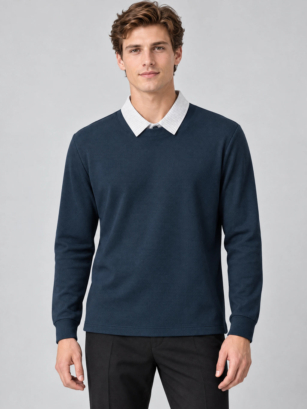 Front studio view of a model wearing a Navy two piece polo shirt with a layered collared neckline and long sleeves.