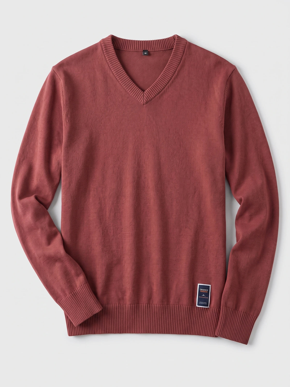 Red cotton V-neck sweater laid flat, showing long sleeves and ribbed neckline, cuffs, and hem.