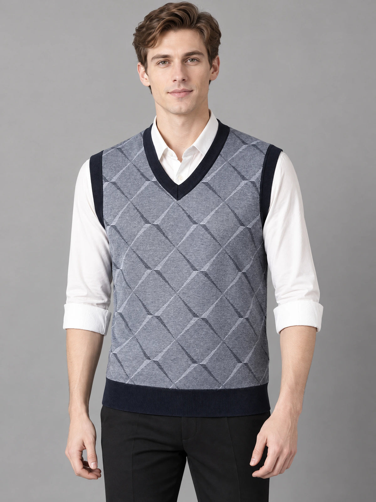 Front studio view of a model wearing a Gray v neck sweater vest with an argyle knit pattern over a collared shirt.