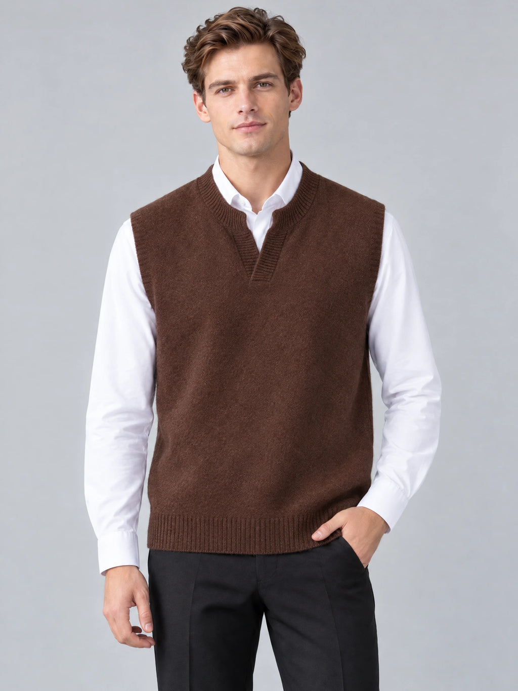 Front studio view of a model wearing a Brown wool v neck sweater vest over a collared shirt.