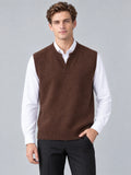 Front studio view of a model wearing a Brown wool v neck sweater vest over a collared shirt.