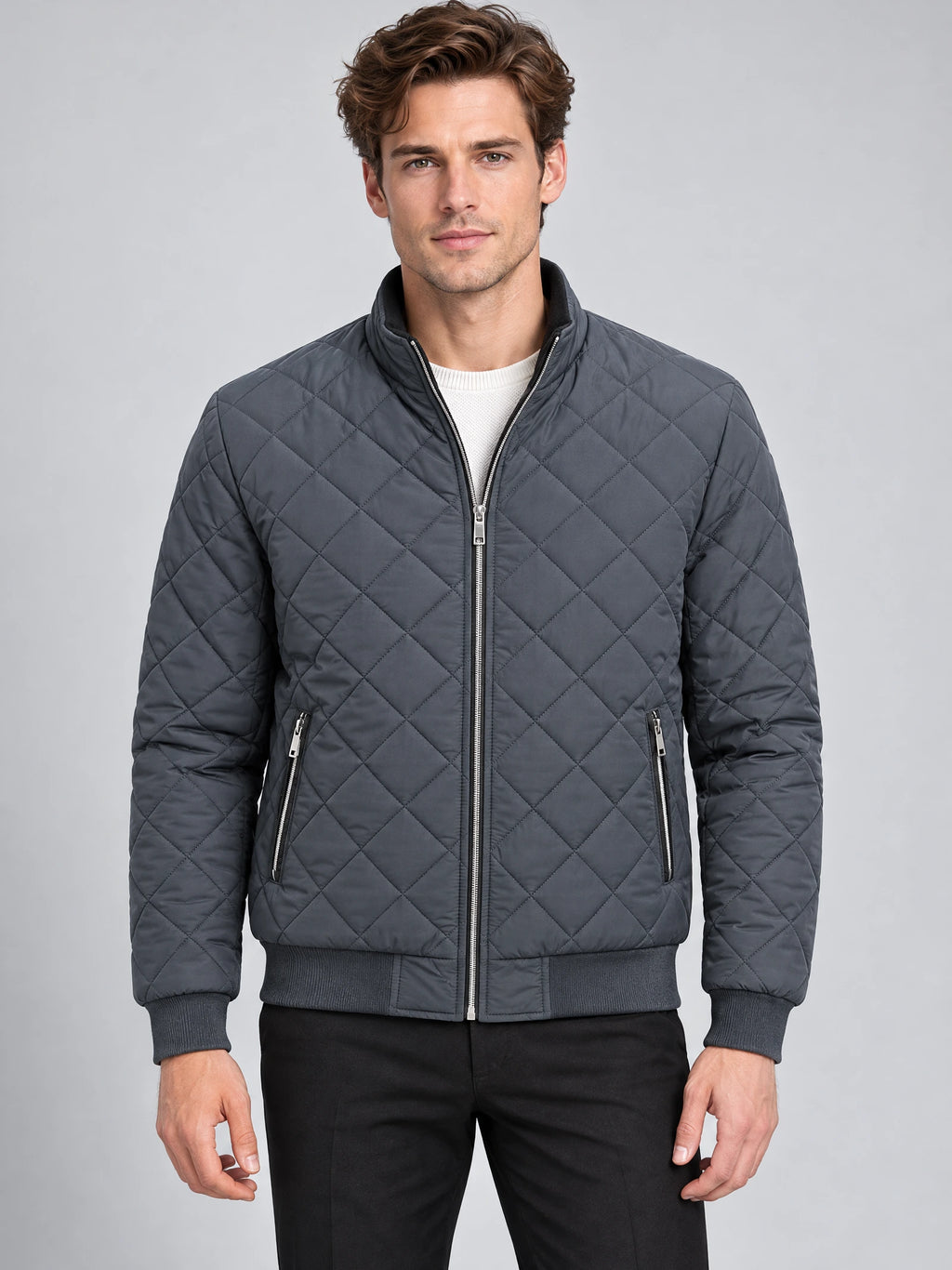 Model wearing a Gray Winter Bomber Jacket with diamond quilting, stand collar, front zipper, and zippered pockets in a studio front view.