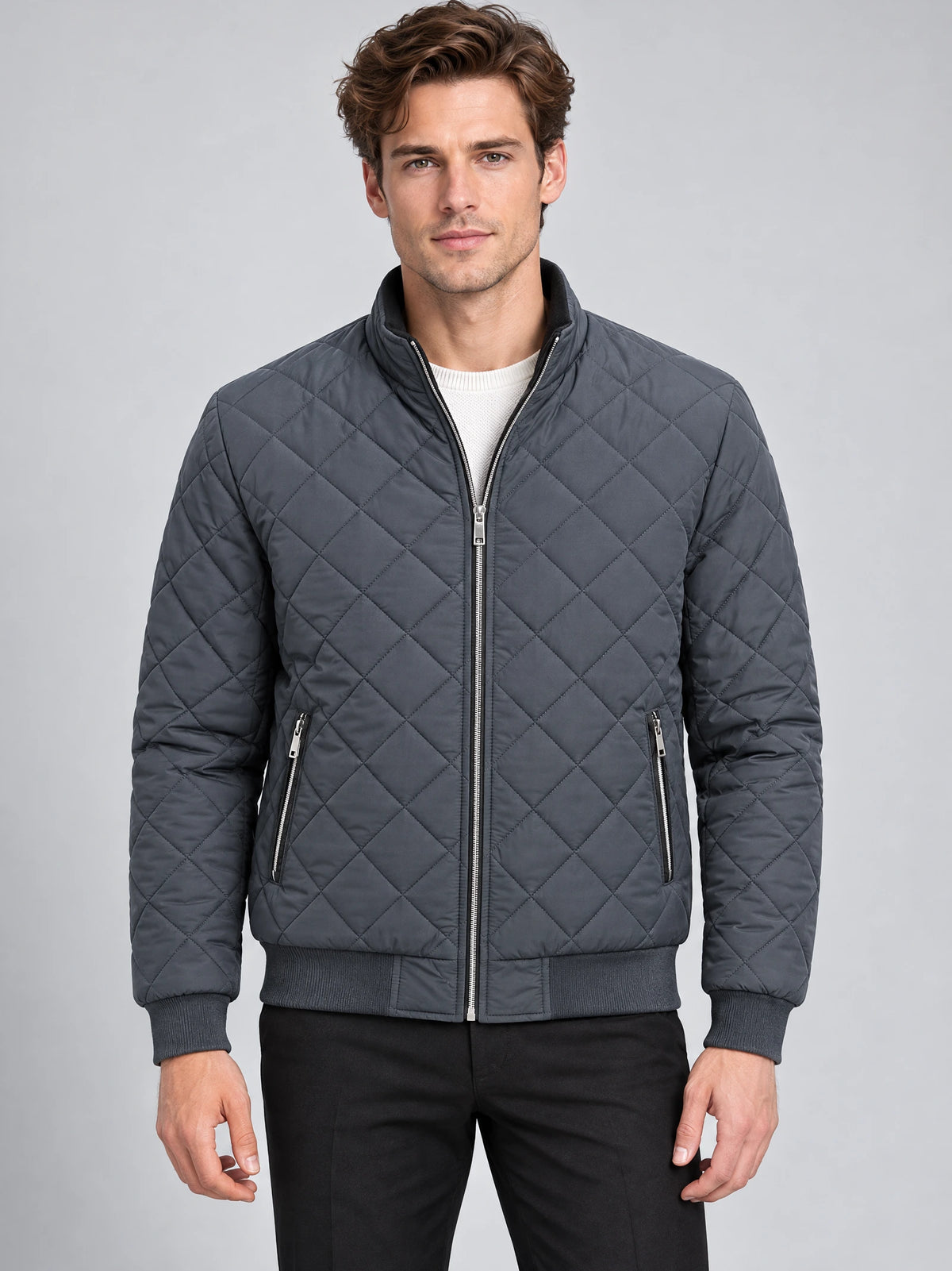 Model wearing a Gray Winter Bomber Jacket with diamond quilting, stand collar, front zipper, and zippered pockets in a studio front view.