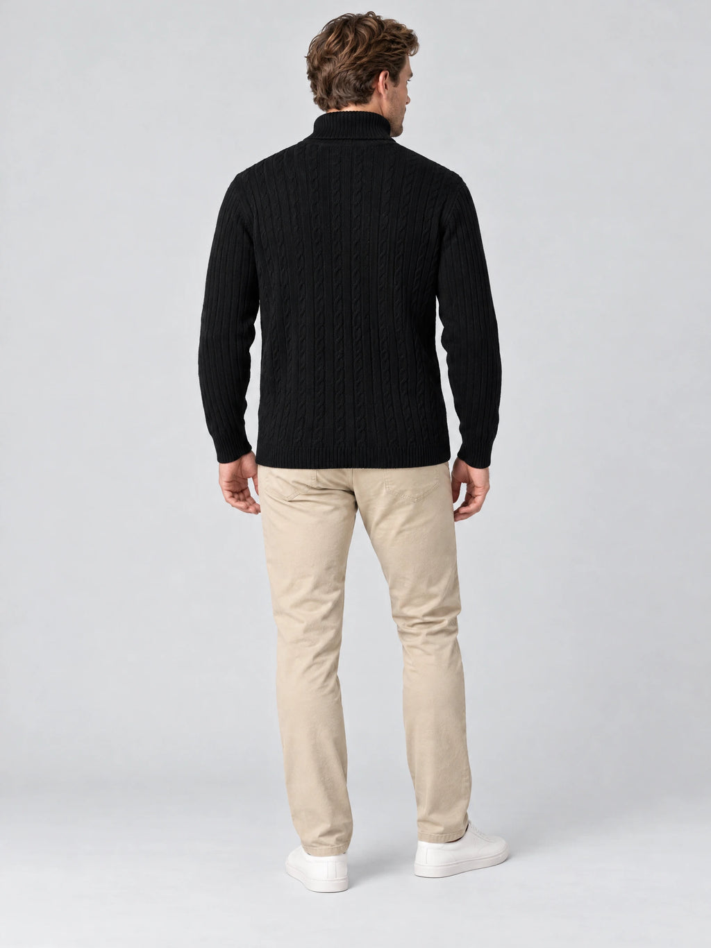 Rear studio view of a model wearing a Black cable-knit turtleneck Winter Sweater with ribbed sleeves and hem.