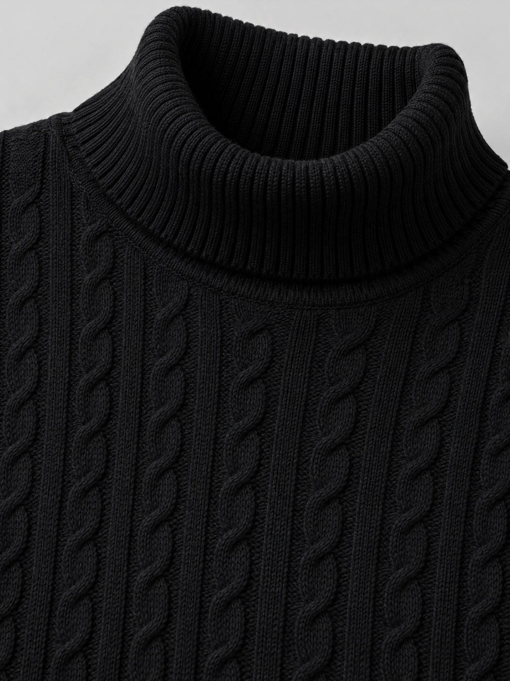 Close-up of the Black men's Winter Sweater showing its ribbed turtleneck and cable-knit texture.
