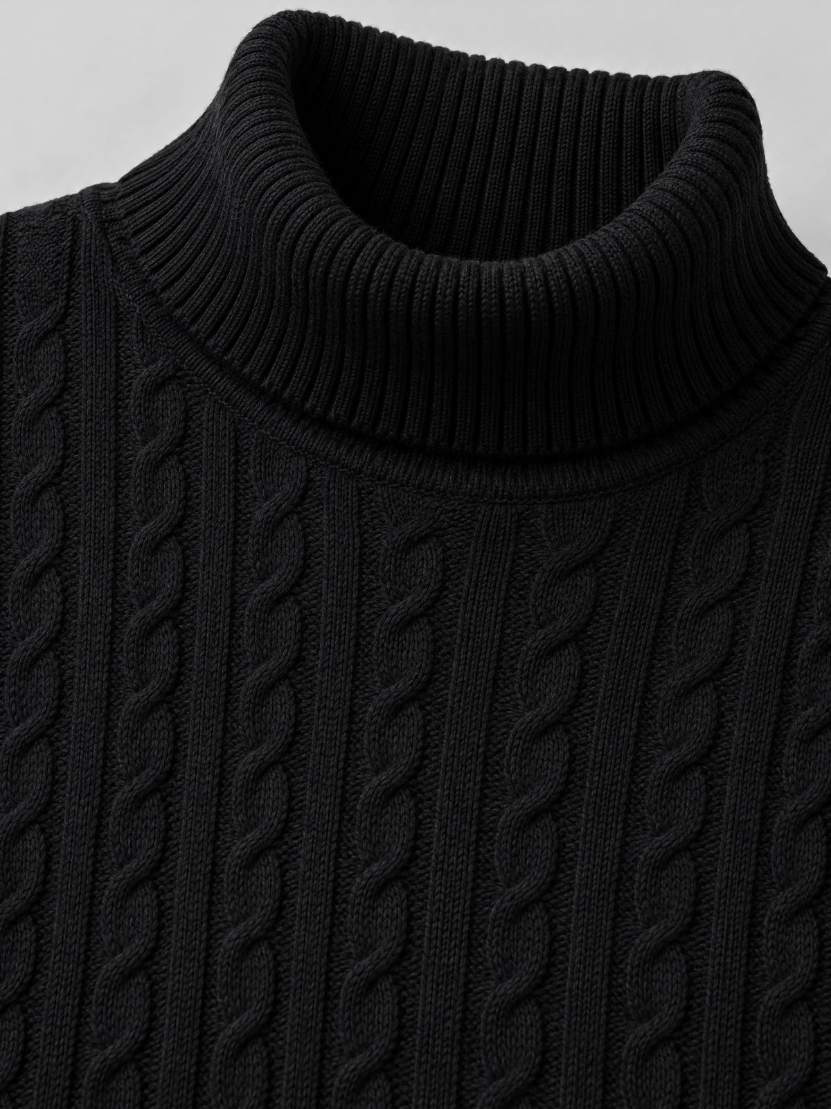 Close-up of the Black men's Winter Sweater showing its ribbed turtleneck and cable-knit texture.