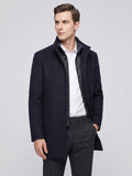 Model wearing a Navy wool overcoat in a front studio view, with a stand collar, button closure, and zip-front inner layer.