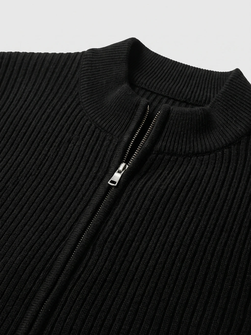 Close-up of the Black men’s zip up cardigan showing the ribbed knit stand collar and front zipper.
