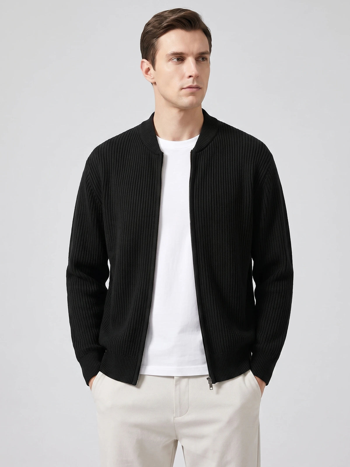 Front studio view of a model wearing a Black ribbed knit zip up cardigan with a stand collar.
