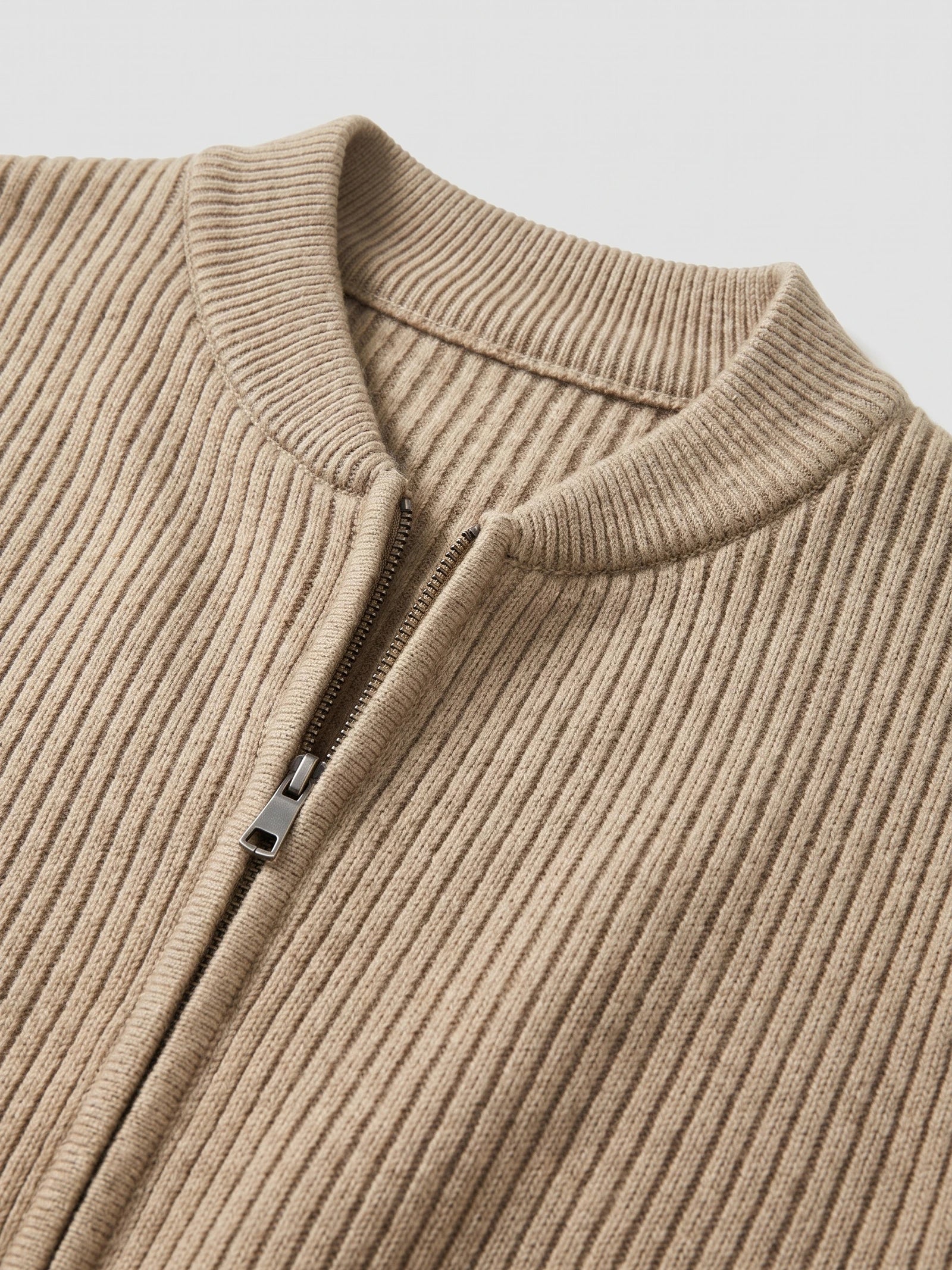 Close-up of the Khaki men’s zip up cardigan showing its rib-knit stand collar and front zipper.