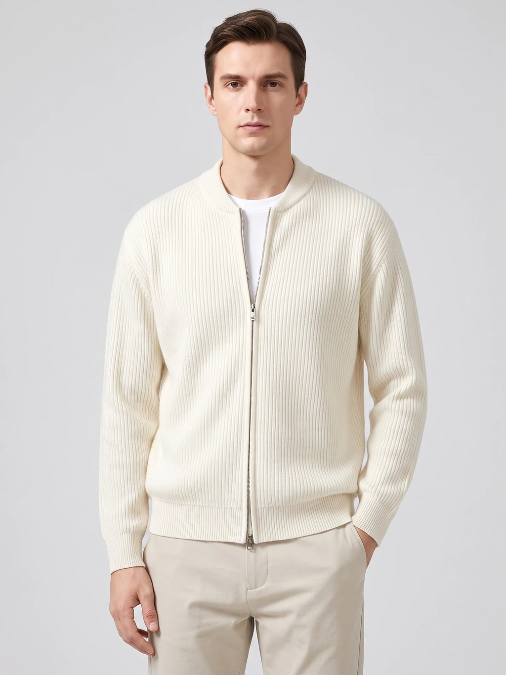 Front studio view of a model wearing a White ribbed knit zip up cardigan with a stand collar and long sleeves.