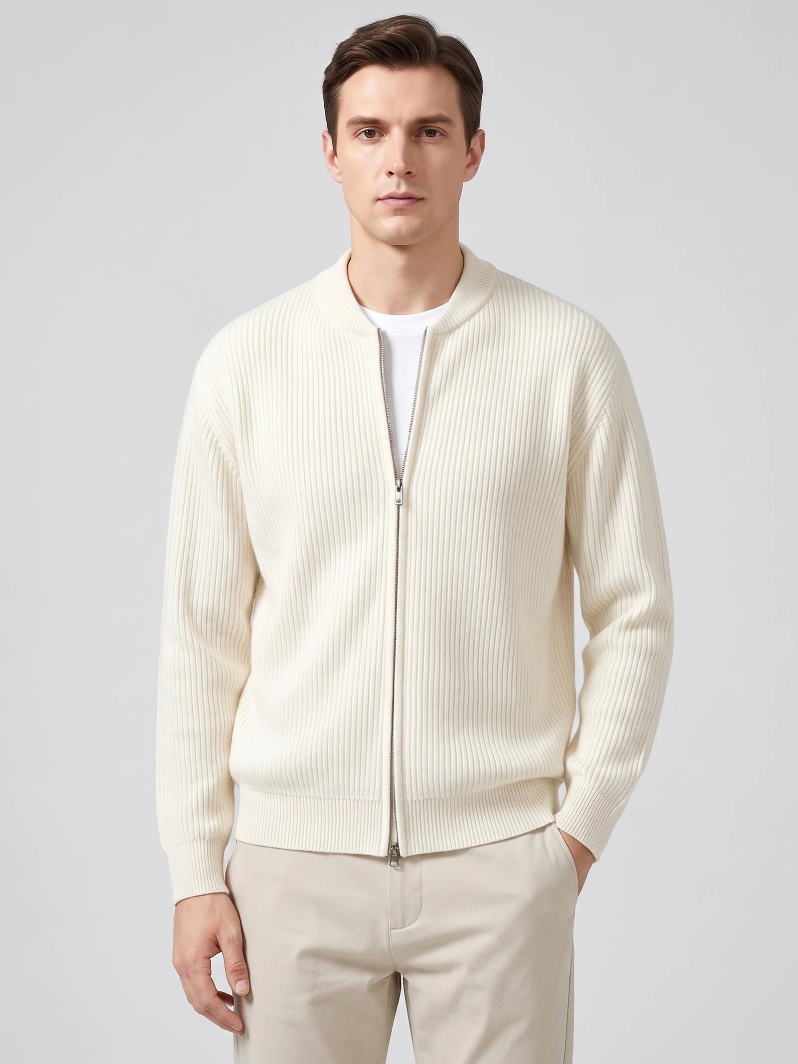 Front studio view of a model wearing a White ribbed knit zip up cardigan with a stand collar and long sleeves.