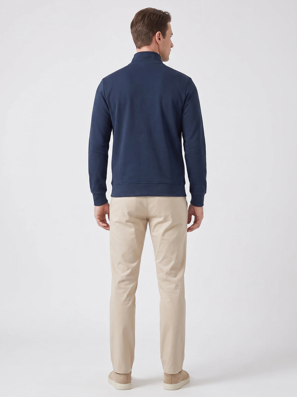 Rear studio view of a model wearing a Navy Zip Up Sweater with a stand collar, ribbed cuffs, and hem.
