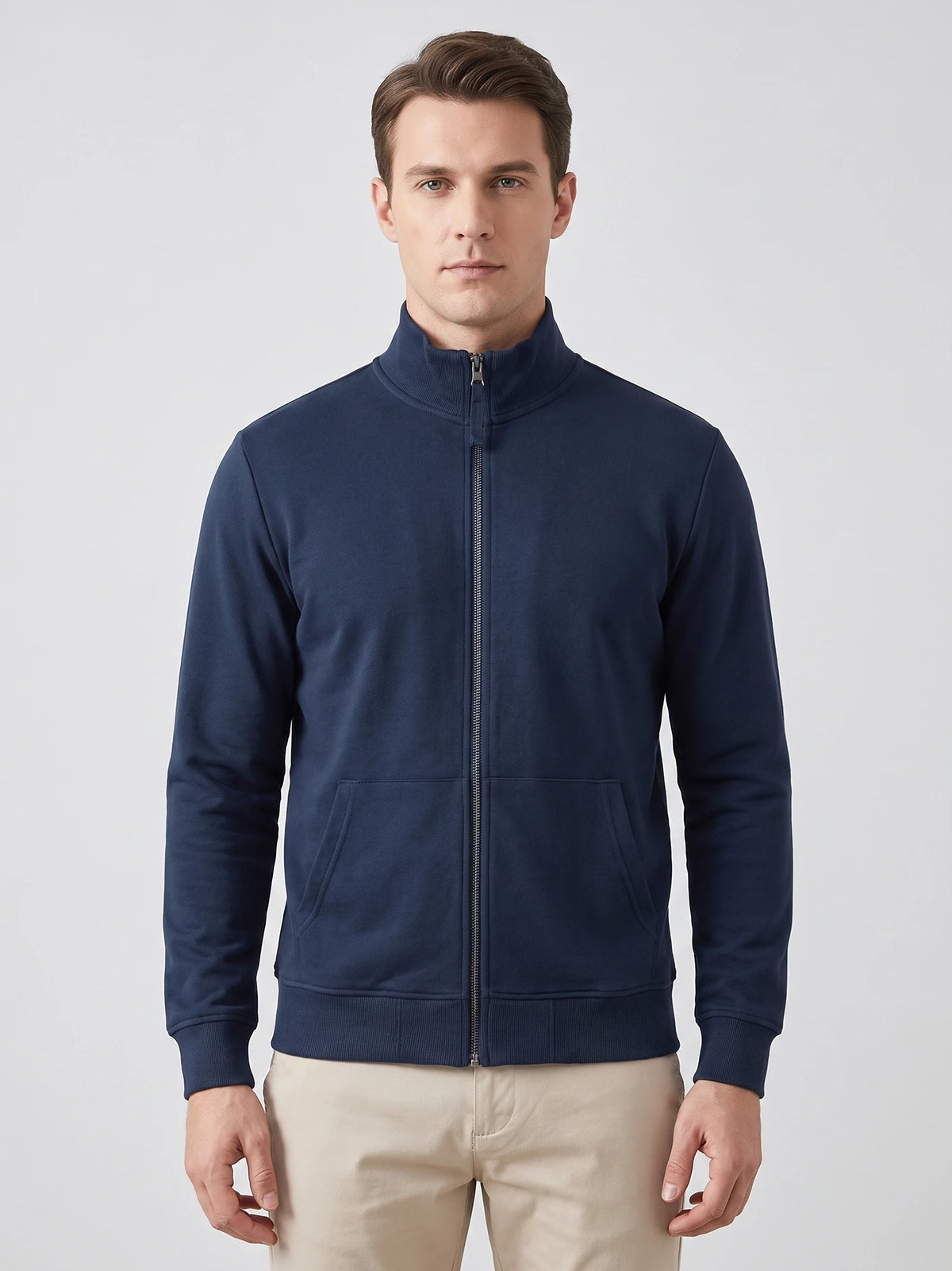 Front studio view of a model wearing a Navy Zip Up Sweater with a ribbed stand collar and front pockets.